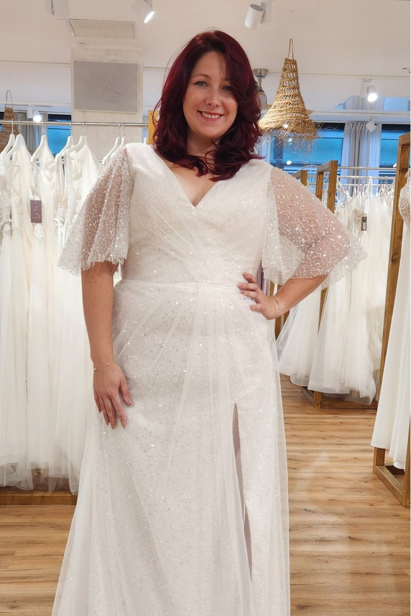 Lachende Braut in Brautkleid GATSBY Curvy mit Fledermausärmeln V-Ausschnitt und Glitzer-Tüllrock